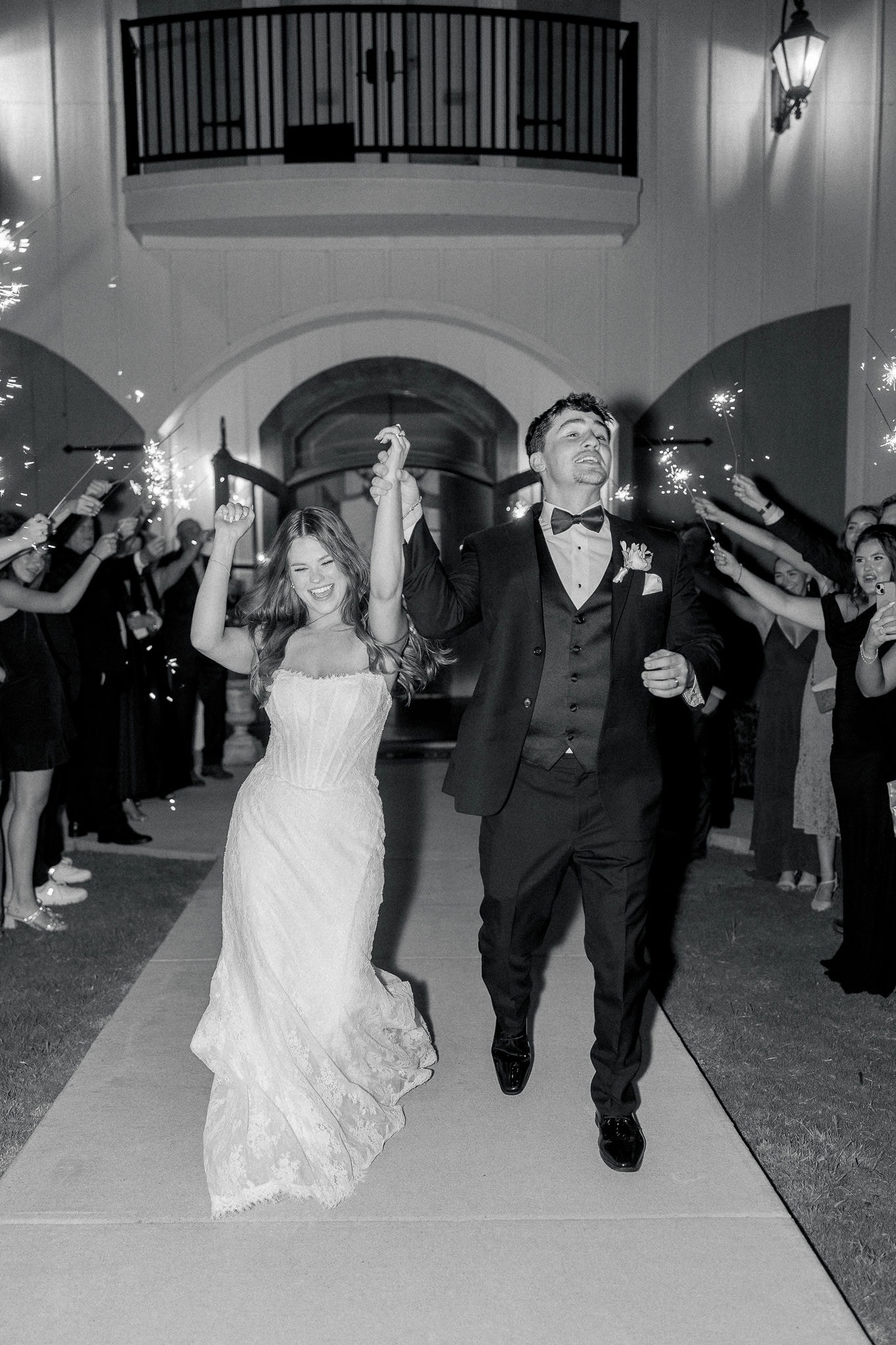 Catherine and Kade running through a sparkler tunnel send-off at The French Farmhouse Venue