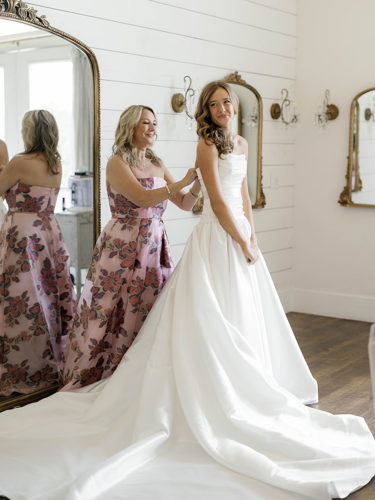 Kylee with her 11 bridesmaids in matching blue and white striped ruffle sets and white slide sandals outside The French Farmhouse Venue